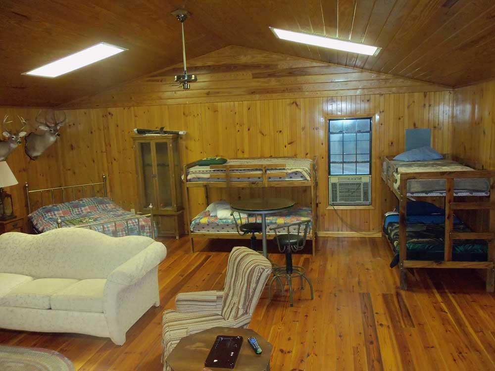 Bunk beds and seating inside the wood-paneled hunting lodge